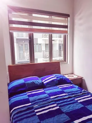 a bedroom with a bed and a window at 2 Bedroom near MOA S Residences in Manila