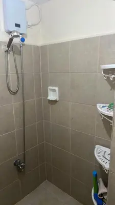 a shower with a shower head in a bathroom at Affordable & Spacious Condo in Makati in Manila