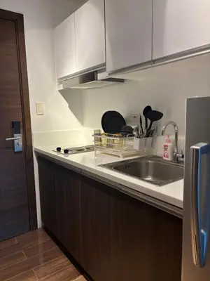 a kitchen with a sink and a counter top at Air Residences in Manila