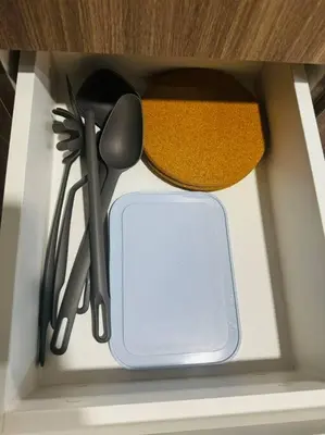 a drawer with some utensils in a kitchen at 10G Cozy Condo at Park McKinley West near Venice Mall in Manila