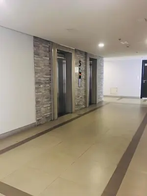 an empty hallway with a tile floor and doors at 81 Newport Boulevard-Hyuna Place, Across NAIA T3 in Manila