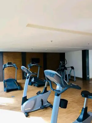 a gym with several exercise bikes in a room at 81 Newport Boulevard-Hyuna Place, Across NAIA T3 in Manila