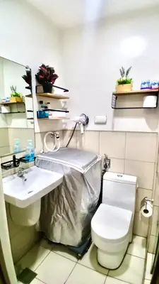 a bathroom with a toilet and a sink at Y&N Staycation Cozy and Aesthetic Unit near to NAIA Airport in Manila