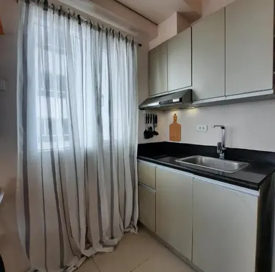 a kitchen with a sink and a window with curtains at ApartHotel Tower22307 in Manila