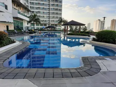 a swimming pool with blue water in a building at ApartHotel Tower22307 in Manila