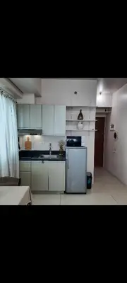 a kitchen with white cabinets and a refrigerator at ApartHotel Tower22307 in Manila