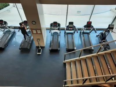a woman running on a treadmill in a gym at ApartHotel Tower22307 in Manila