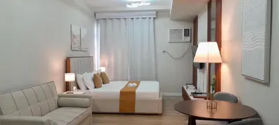 a hotel room with a bed and a couch at La Nobleza Manila in Manila