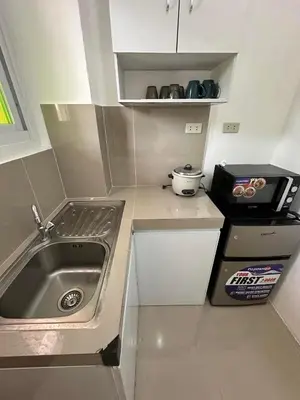 a small kitchen with a sink and a stove at B&CH RESIDENCE Transient in Calamba