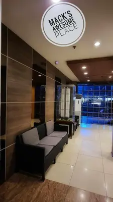 a waiting room with a couch in a building at Macks Awesome Place 22 Fast Wifi Premium Netflix in Manila