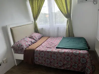a small bed in a room with a window at STANFORD SUITES 2 UNIT 755 lilian in Silang