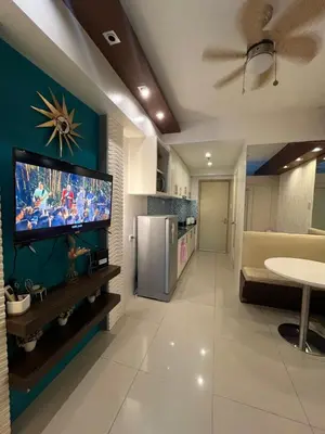 a living room with a flat screen tv on a wall at Sea Residences by-Azenith in Manila