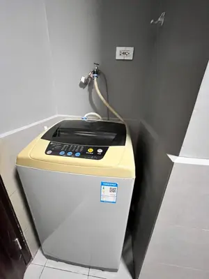 a washing machine with a cord on top of it at The RADIANCE MANILA BAY in Manila
