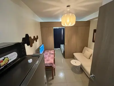 a small living room with a couch and a table at Shore 2 2-Bed Balcony City View WiFi Netflix near MOA 834 in Manila