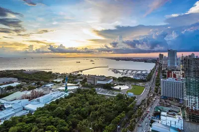 an aerial view of a city with the ocean at SM Breeze one bedroom in Manila