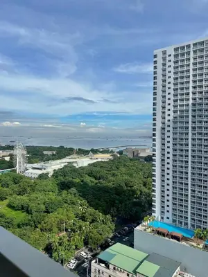 an aerial view of a large tall building at Coast Residences Near MOA and NAIA Manila Bay View with Pool in Manila