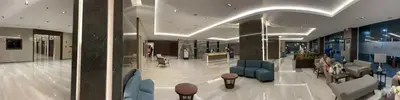 a lobby with chairs and tables in a building at Coast Residences Near MOA and NAIA Manila Bay View with Pool in Manila