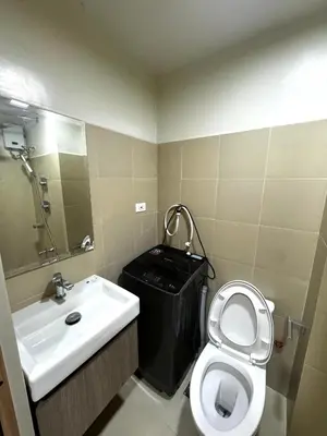 a small bathroom with a sink and a toilet at Bachelor Pad Shore 3 Residences in Manila