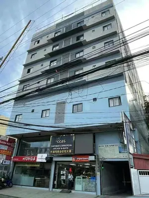 a tall building with a store in front of it at cartimar hotel condo in Manila