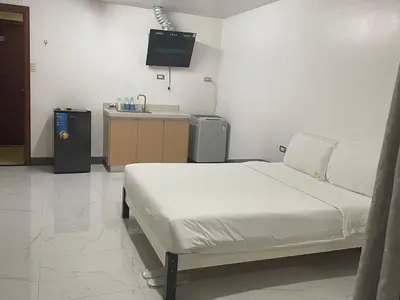 a hospital room with a bed and a television at cartimar hotel condo in Manila