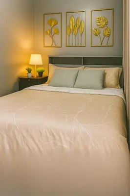 a large bed with a white comforter in a bedroom at SkyViewCondotel Breeze Residences Staycation near WTC,PICC,MOA,NAIA,OCEAN PARK in Manila