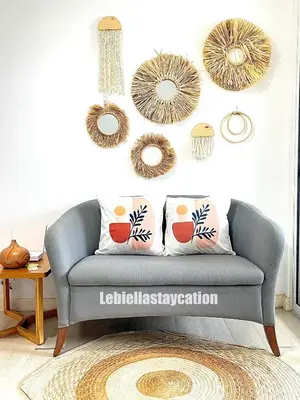 a living room with a gray couch and mirrors at azure urban resort residences in Manila