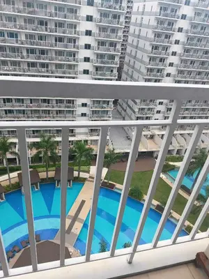 a view of the pool from the balcony of a apartment at Shell Residences Condotel Apartment in Manila