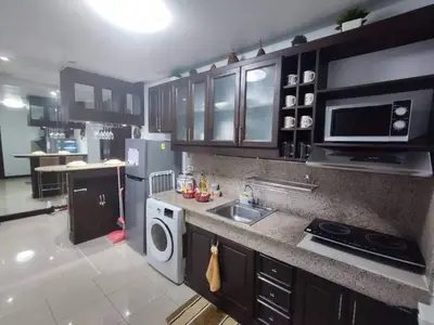 a kitchen with a sink and a stove and a microwave at Near Manila Airport COZY 02 Bedroom Condo With Pool - 4R in Manila