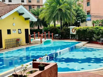 a large swimming pool with blue water in a building at Near Manila Airport COZY HOTEL STYLE Condo With Pool 7A in Manila