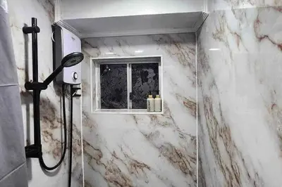 a bathroom with a window and a shower at Near Manila Airport COZY HOTEL STYLE Condo With Pool 7A in Manila