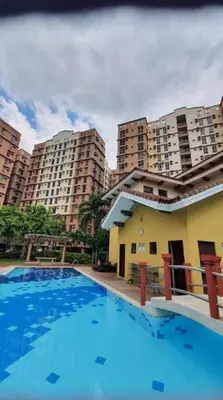 a large swimming pool in front of tall buildings at Near Manila Airport COZY HOTEL STYLE Condo With Pool 7A in Manila