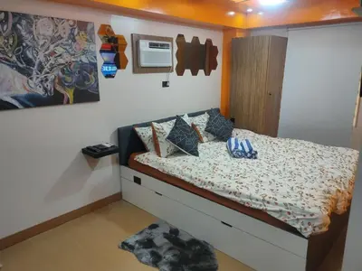 a bedroom with a bed and a wall at Near Manila Airport, COZY Hotel Style Studio Condo 5G in Manila