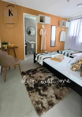 a bedroom with two beds and a bathroom at Sleep With Me Room cozy stay near Araneta Center in Manila