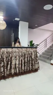 a woman standing behind a counter in a building at Sleep With Me Room cozy stay near Araneta Center in Manila
