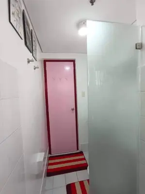 a bathroom with a red door and a red and white floor at Near Manila Airport COZY 01 Bedroom Condo - 10K in Manila