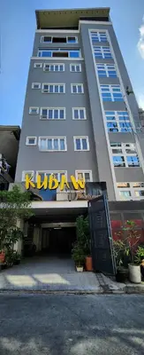 a tall building with a sign on the front of it at Tranquil Haven Relaxing Retreat near Araneta in Manila