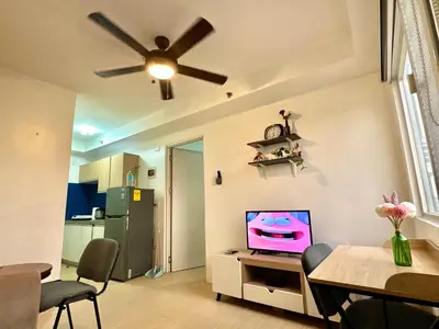 a living room with a television on a table at Luna Hive Place in Malapandan