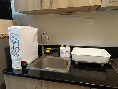 a kitchen counter with a sink and a sink at Cozy Staycation at Destiny's Crib Fame, Edsa Mandaluyong in Manila