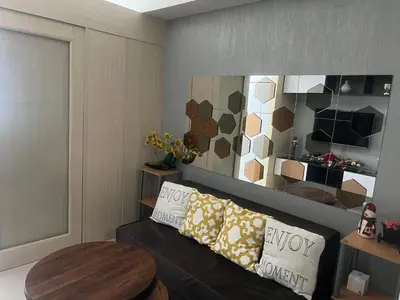 a living room with a couch and a table at Jazz Residences Luxury Staycation in Manila