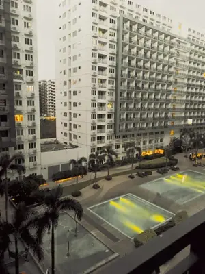 a view of a large building with a parking lot at Sea Residences Condotel GudStay in Manila