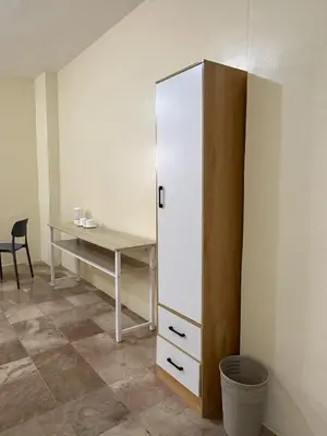 a room with a desk and a white cabinet at W Spot Property in Manila