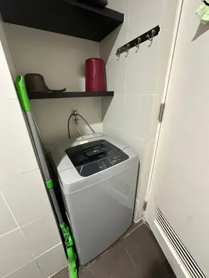 a washer and dryer in a small room at Cozy Room with Citiview at Greenbelt Makati in Manila