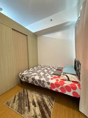 a small bedroom with a bed with a rug at Netflix and Chill at Ephra Homestay - Grace Residences Tower 4 in Manila