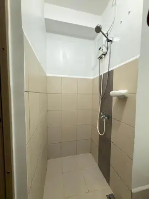 a shower with a shower head in a bathroom at Netflix and Chill at Ephra Homestay - Grace Residences Tower 4 in Manila