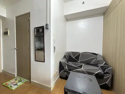a living room with a couch and a door at Netflix and Chill at Ephra Homestay - Grace Residences Tower 4 in Manila