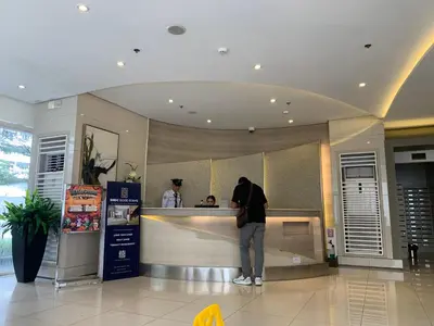 a man standing at a counter in a store at Netflix & Chill at Pablo's Homestay-Grace Residences Tower 4 in Manila