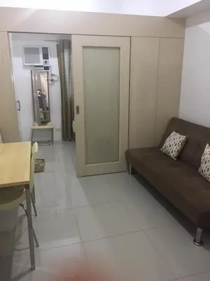 a living room with a couch and a table at 20th flr SMDC Lights Residence Mandaluyong City Philippines in Manila