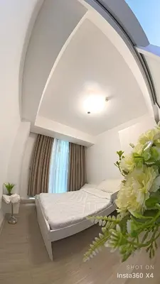 a room with a bed and flowers in a room at DT SUITES AND RESORTS at Azure Paranaque in Manila