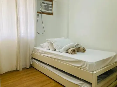 a bed with towels on it in a room at 2 Bedroom with Resort Facilities near BGC and Makati in Manila