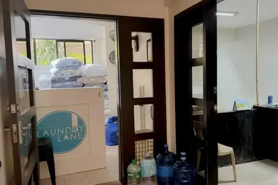 an open door to a living room with a laundry room at 2 Bedroom with Resort Facilities near BGC and Makati in Manila